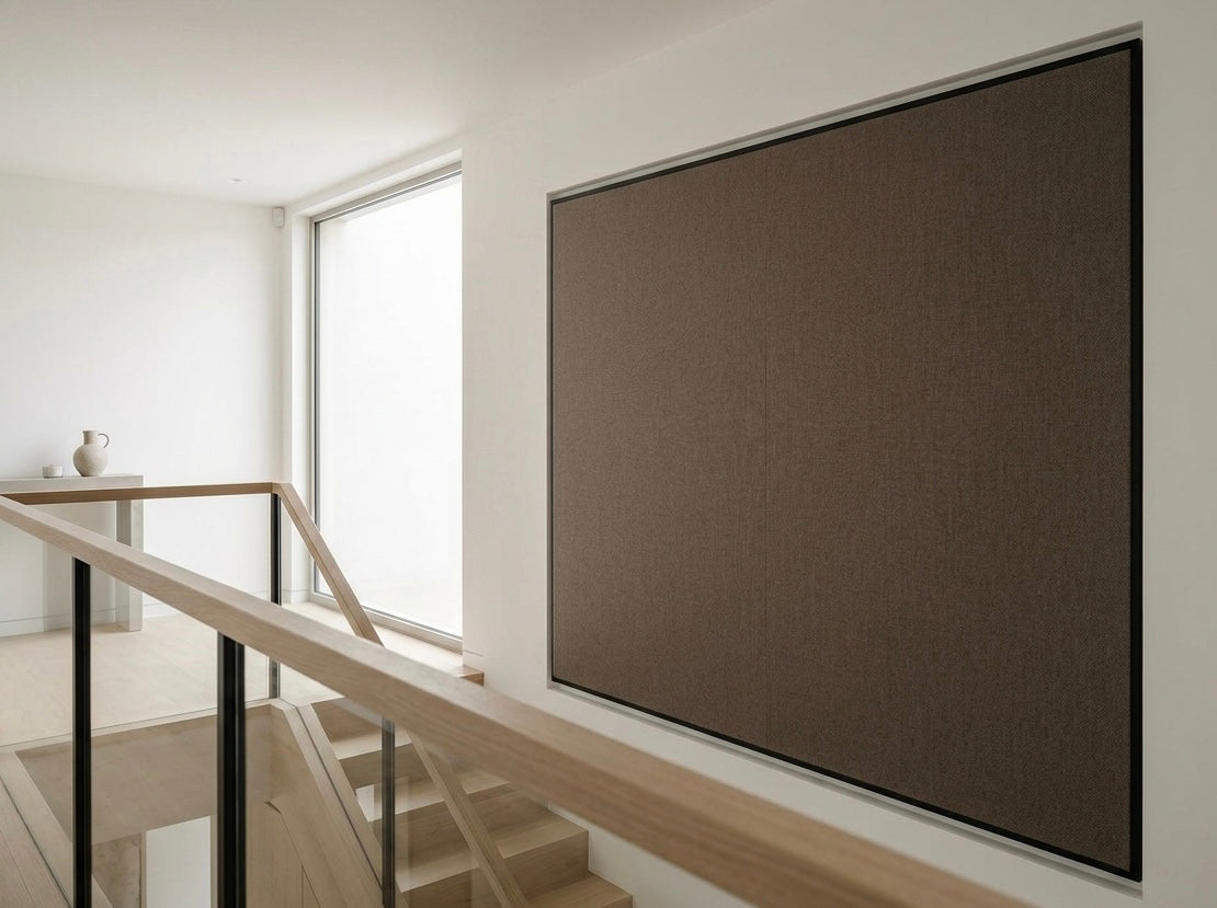 Modern interior with a large screen on a wall next to a staircase