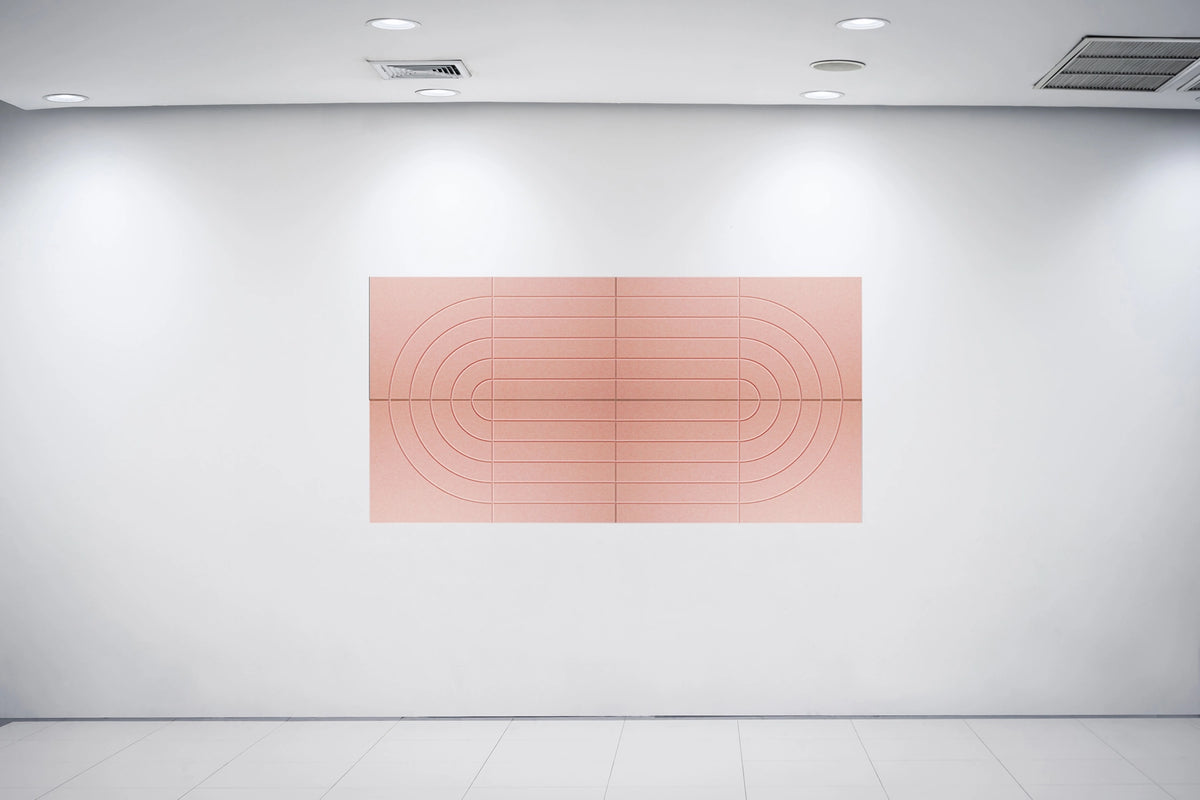 A minimalist art print featuring concentric arches and lines in a dusty rose color, displayed on a clean white gallery wall under recessed lighting.