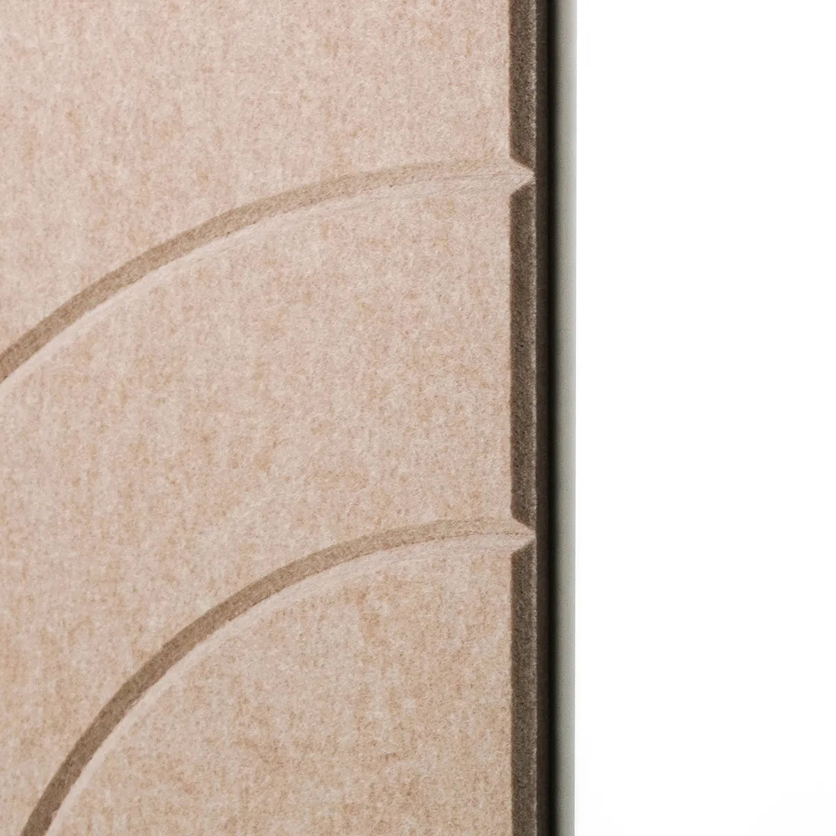 Close-up of a beige textured surface with embossed curved lines and a dark vertical edge, shown against a white background.