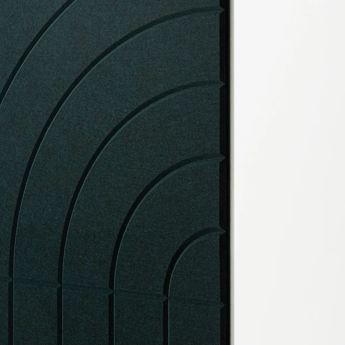 Dark green textured panel with concentric arch patterns, shown next to a plain white vertical surface.