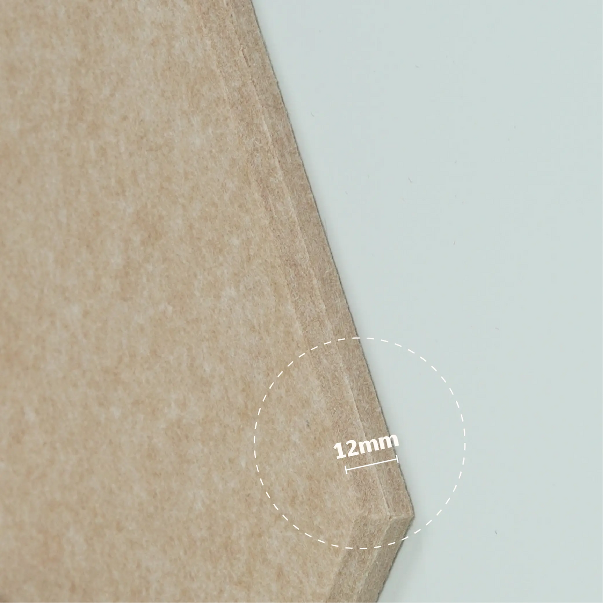 Close-up of a light brown wood veneer sheet corner with a 12mm thickness measurement overlay and a dashed circle indicating the edge depth.