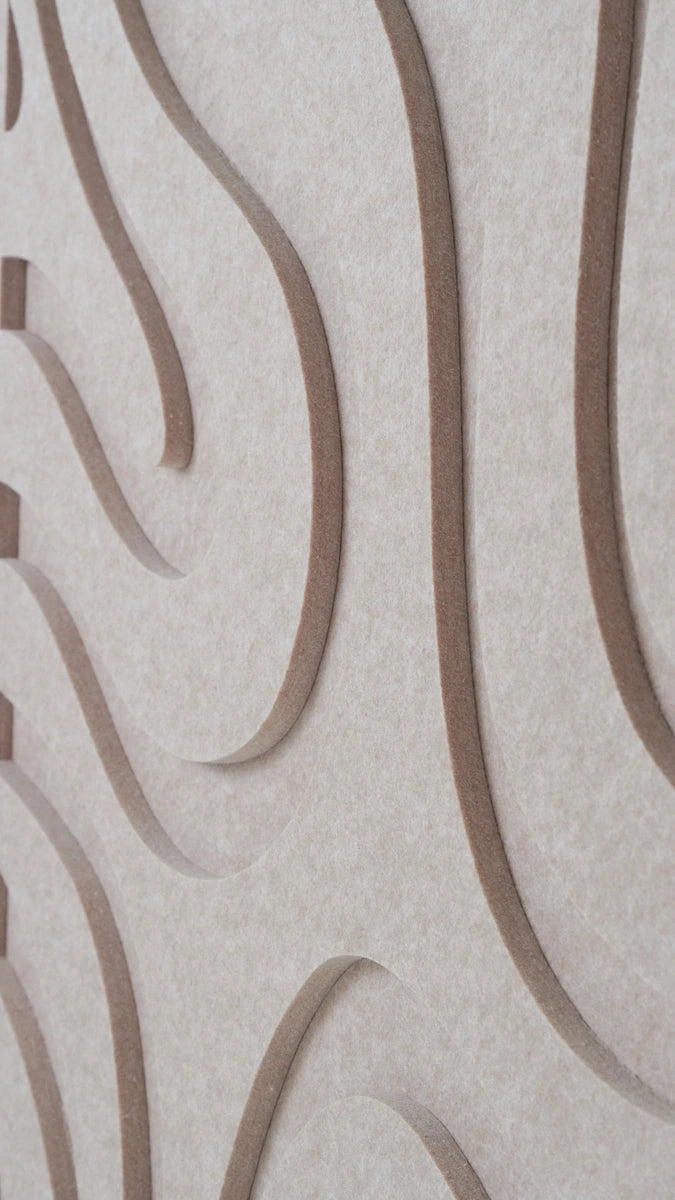 Close-up of a textured beige surface with a repeating wavy pattern in a medium taupe-brown color.
