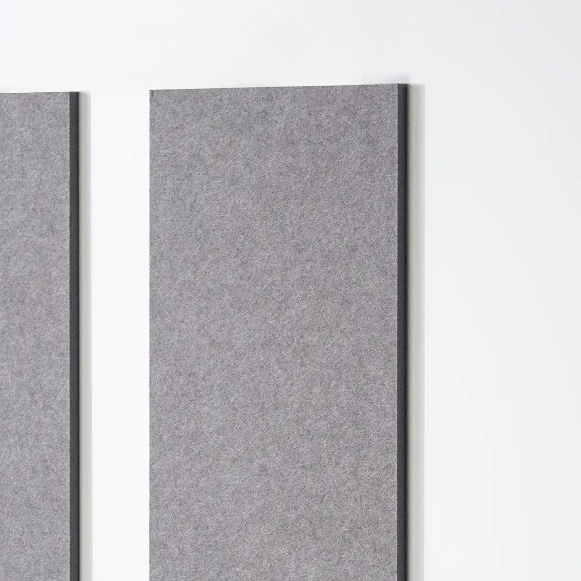 Two rectangular gray felt wall panels mounted vertically on a white wall, shown in a clean interior-style product shot.