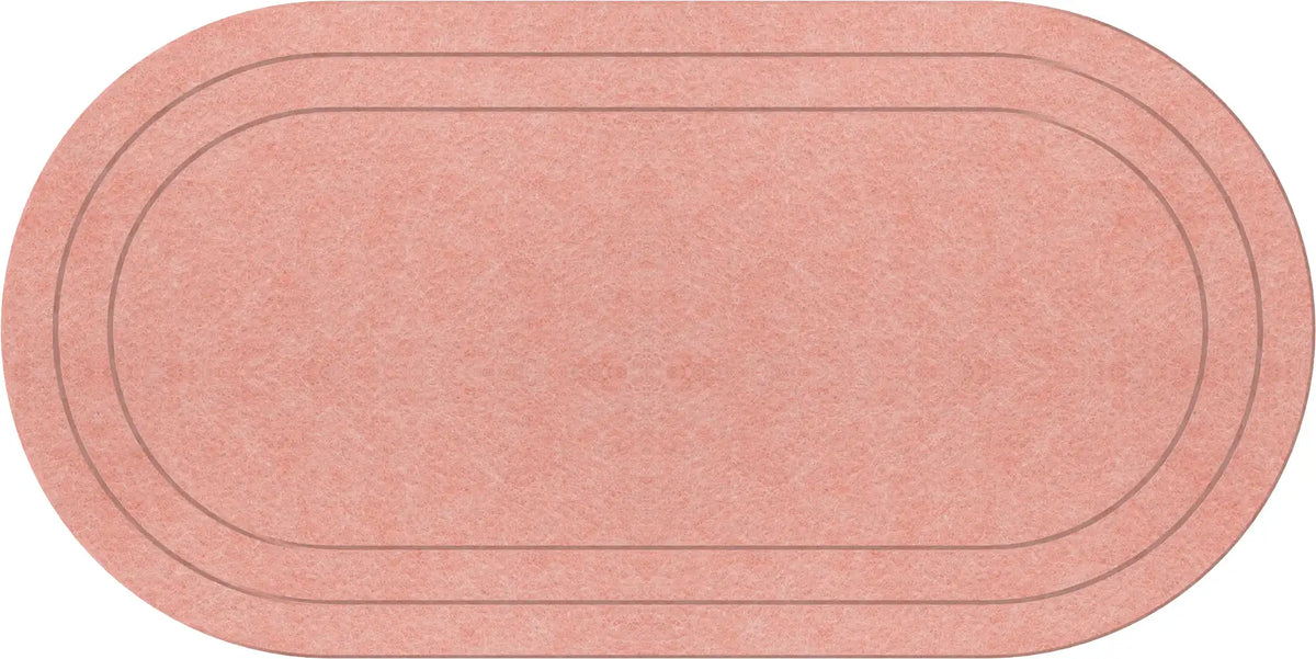 An oval-shaped runner rug in a coral color with a textured surface and two thin dark gray concentric lines.