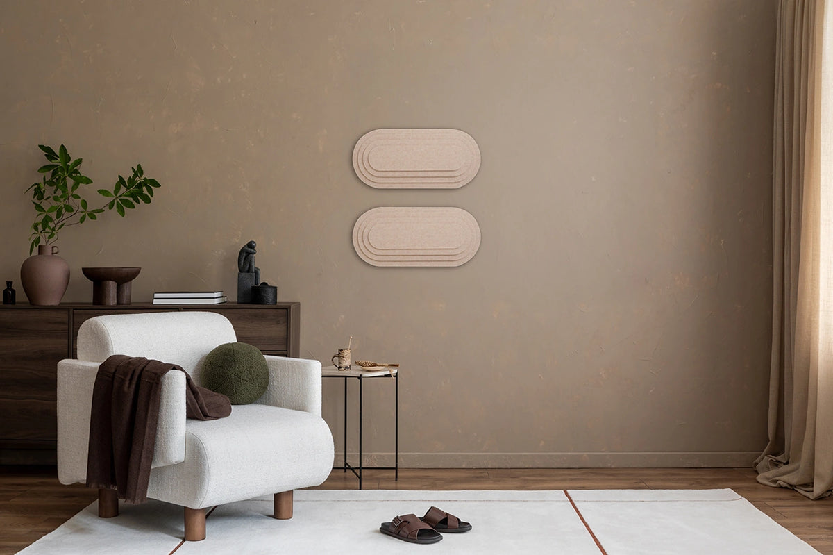 A room with 'Topo' 3D panels on the wall, a wooden table, a beige armchair, a standing lamp, and various decorative items.