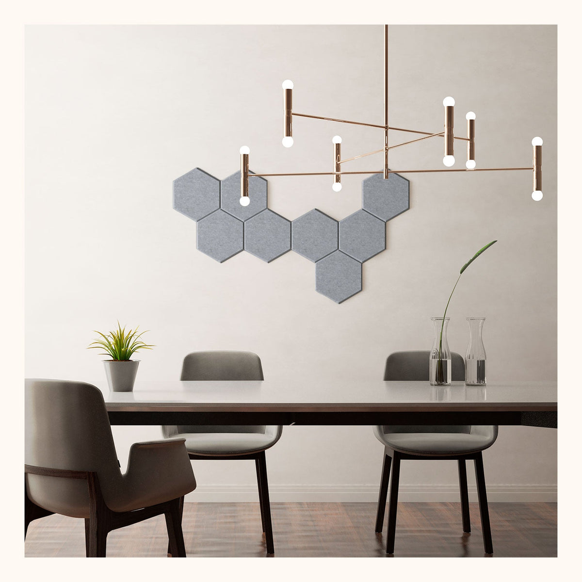 An 8-piece hexagon-shaped wall art in mono color, hanging above a dining table with chairs in a cozy room setting.