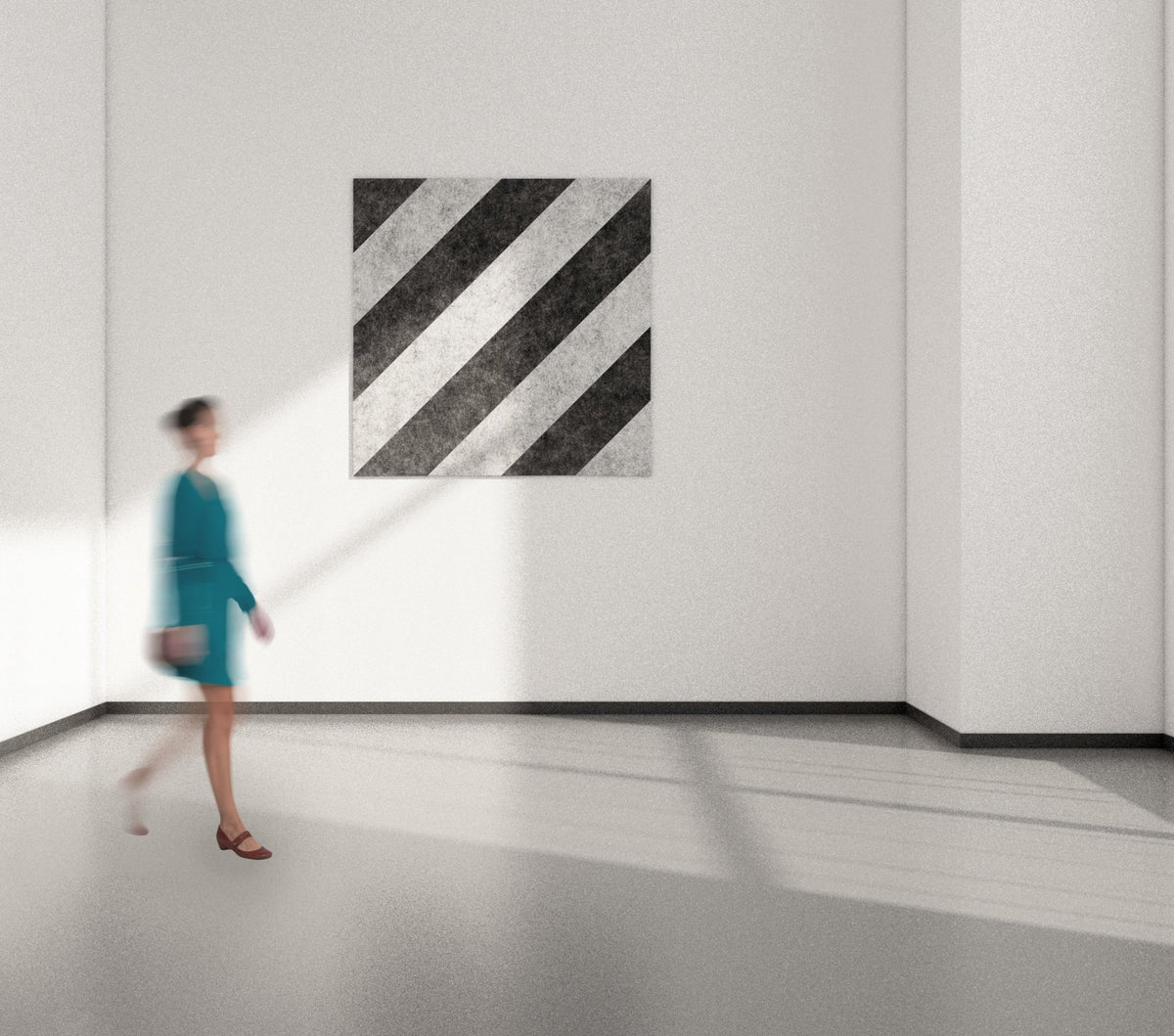 An acoustic wall panel of black and white stripes on a wall, with a person walking past it in an office setting