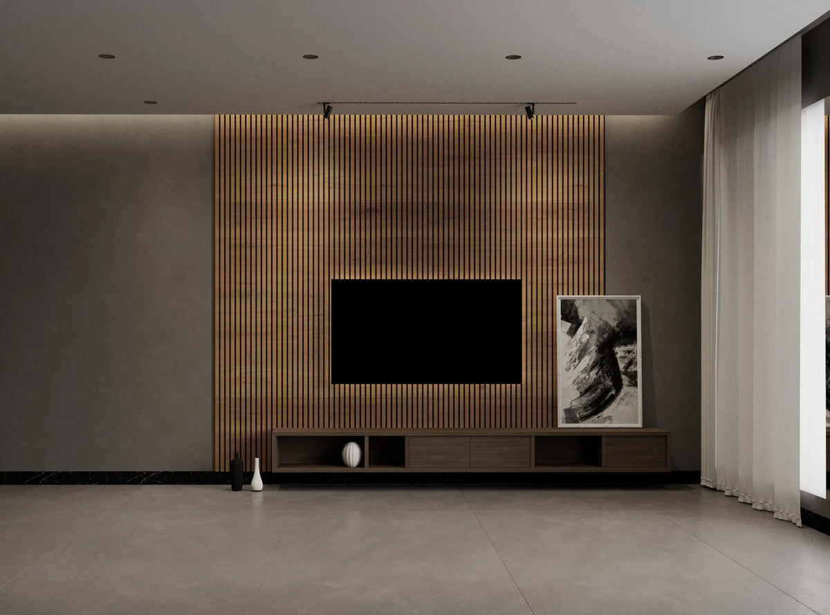 A modern living room interior featuring a large black flat-screen TV mounted on a vertical slatted wood accent wall above a low wooden media console. A black-and-white framed artwork stands to the right, with a gray concrete floor and light curtains on the right side.