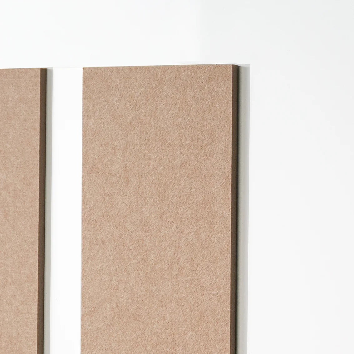 Two rectangular tan textured panels mounted vertically against a white wall, shown in a close-up interior-style shot.