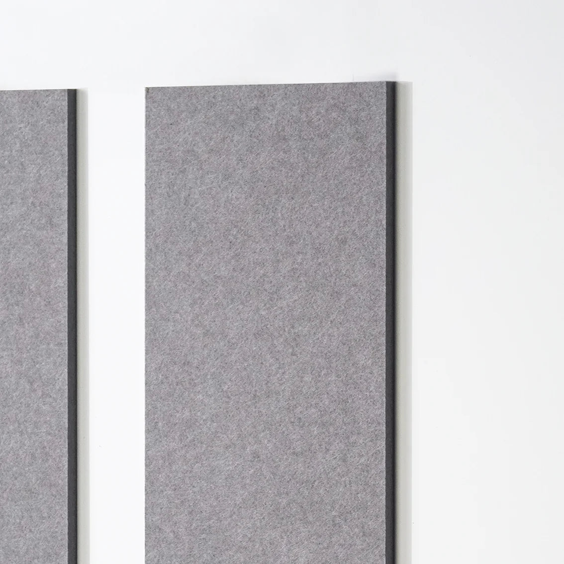 Two rectangular gray felt wall panels mounted vertically on a white wall, shown in a clean interior-style product shot.
