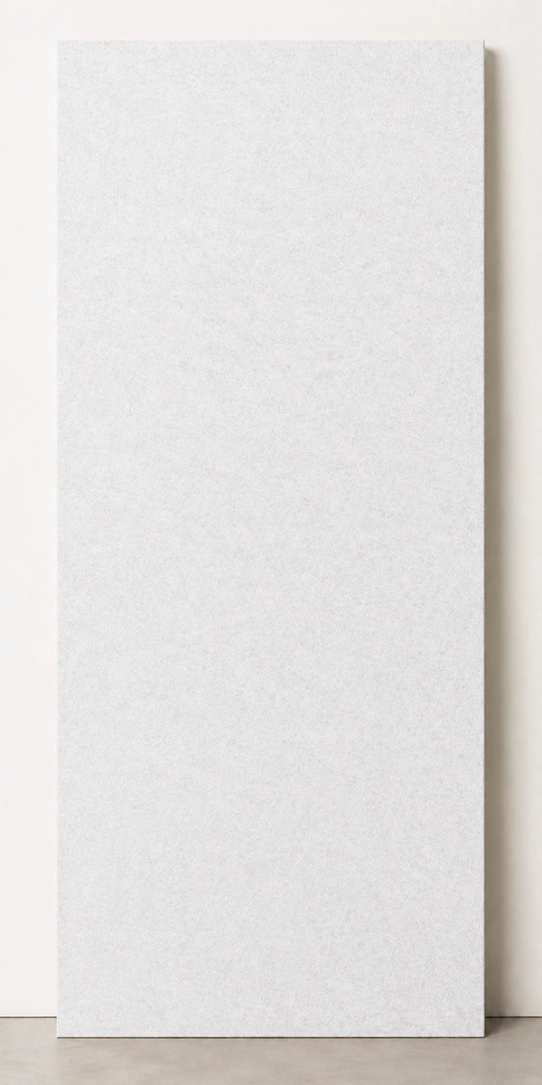 A tall, rectangular white textured panel or board standing upright against a light neutral wall on a concrete floor.