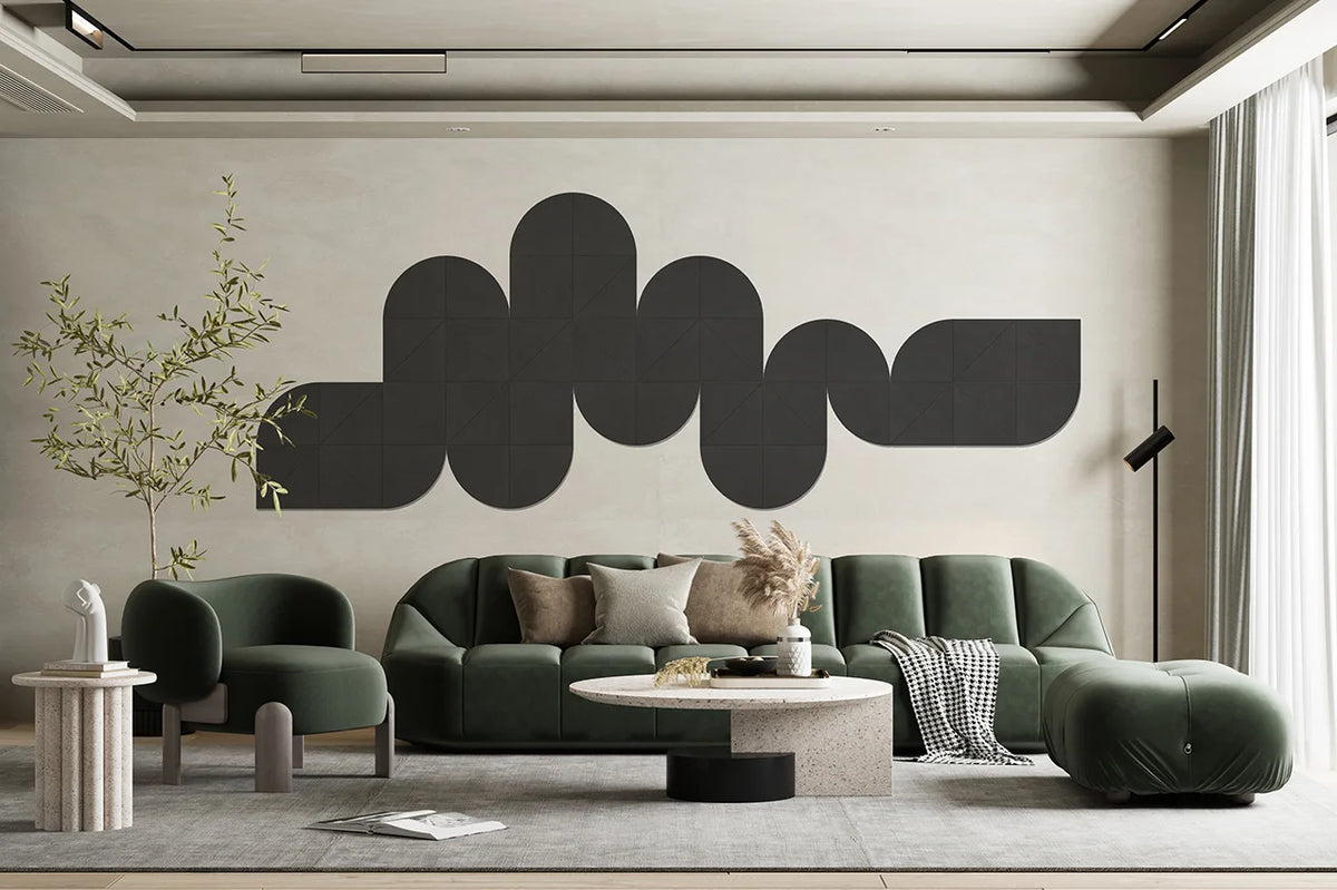 A modern living room featuring a large black abstract wavy wall art piece mounted on a beige wall above a green sectional sofa and matching green armchair.