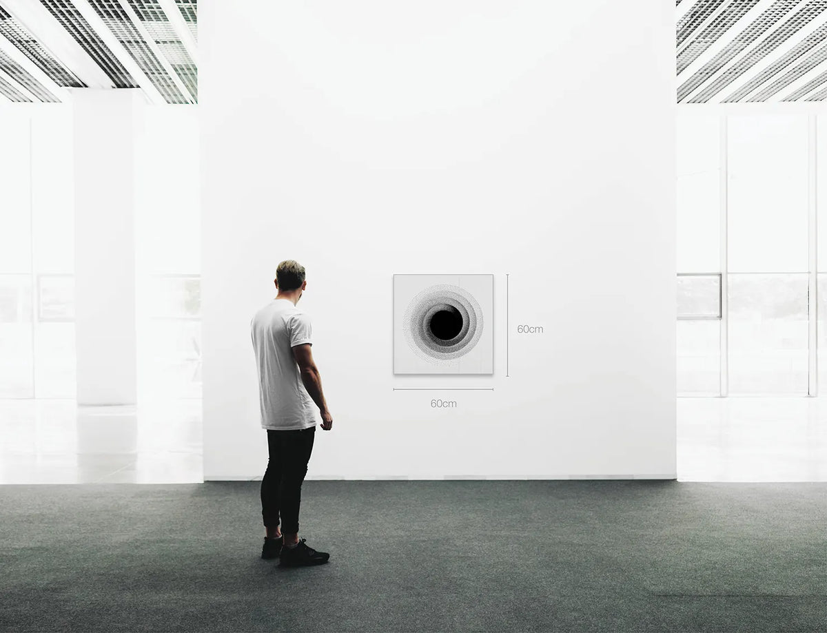 A man stands in a minimalist white gallery space, facing a square wall-mounted circular artwork with dimension labels reading 60cm by 60cm.