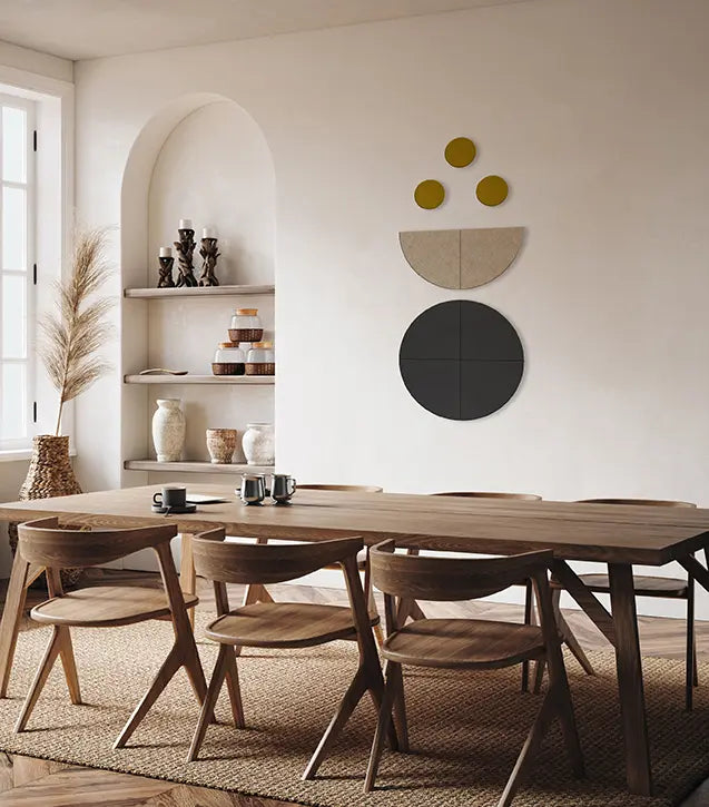 A modern dining room scene with a long wooden dining table and matching wooden chairs, set in a warm neutral interior with built-in shelves, a window, and abstract wall decor.
