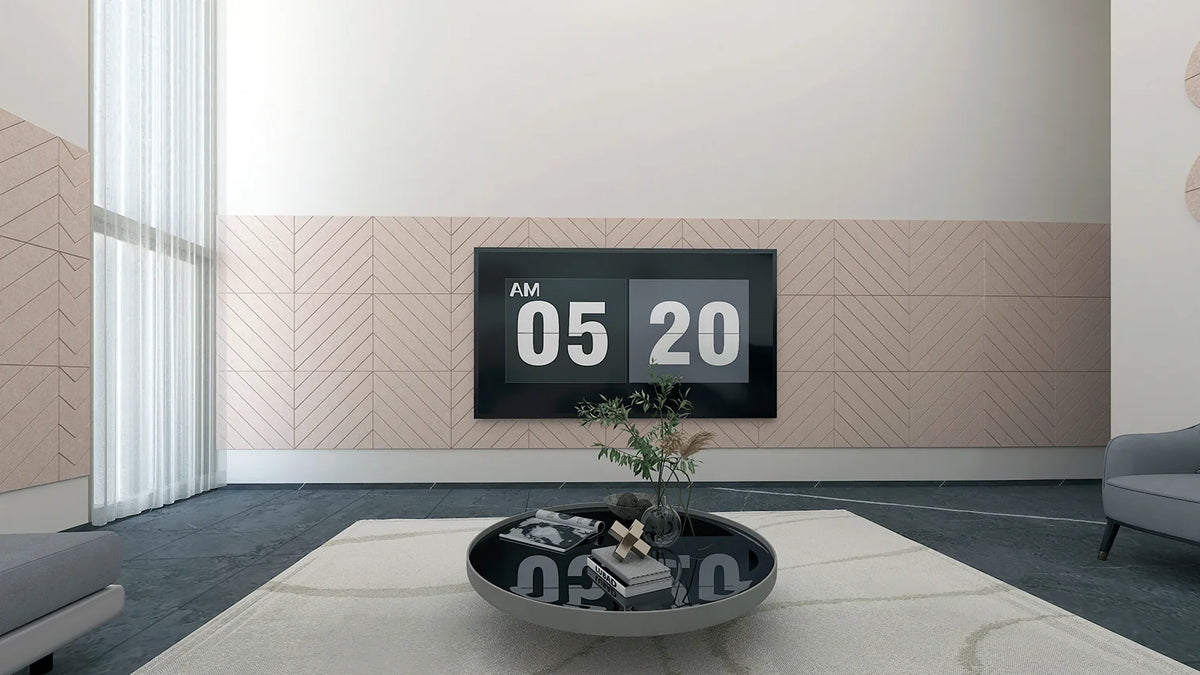 Chevron-pattern noise-absorbing panels installed on the walls in a room with television and plant