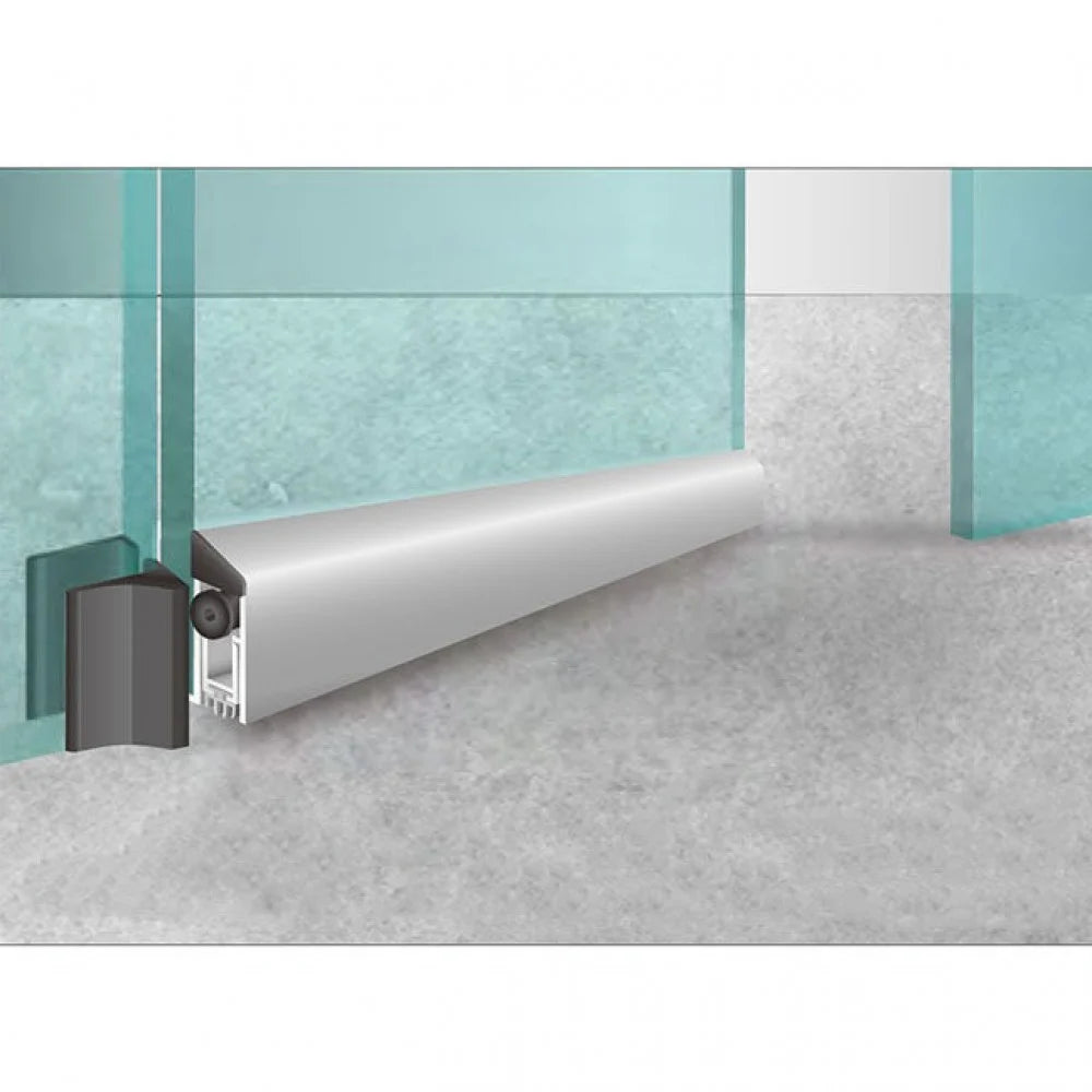 A door drop seal installed on the bottom of a glass door to prevent drafts and soundproof the room.