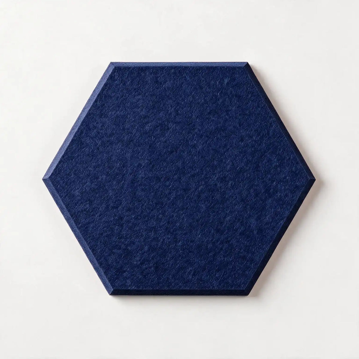A hexagonal felt tile in a navy color with a light wood border, shown from a top-down perspective on a clean white background.