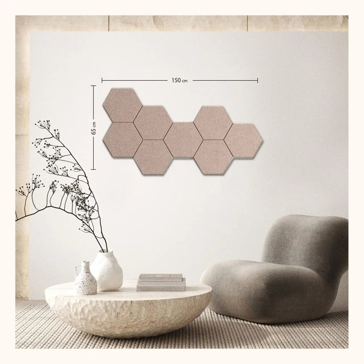 A set of six beige hexagonal wall tiles arranged in a row on a light wall, with dimension lines indicating a width of 150 cm and height of 65 cm. The scene is styled as a modern living room with a textured coffee table, a white vase with dried branches, and a gray lounge chair.
