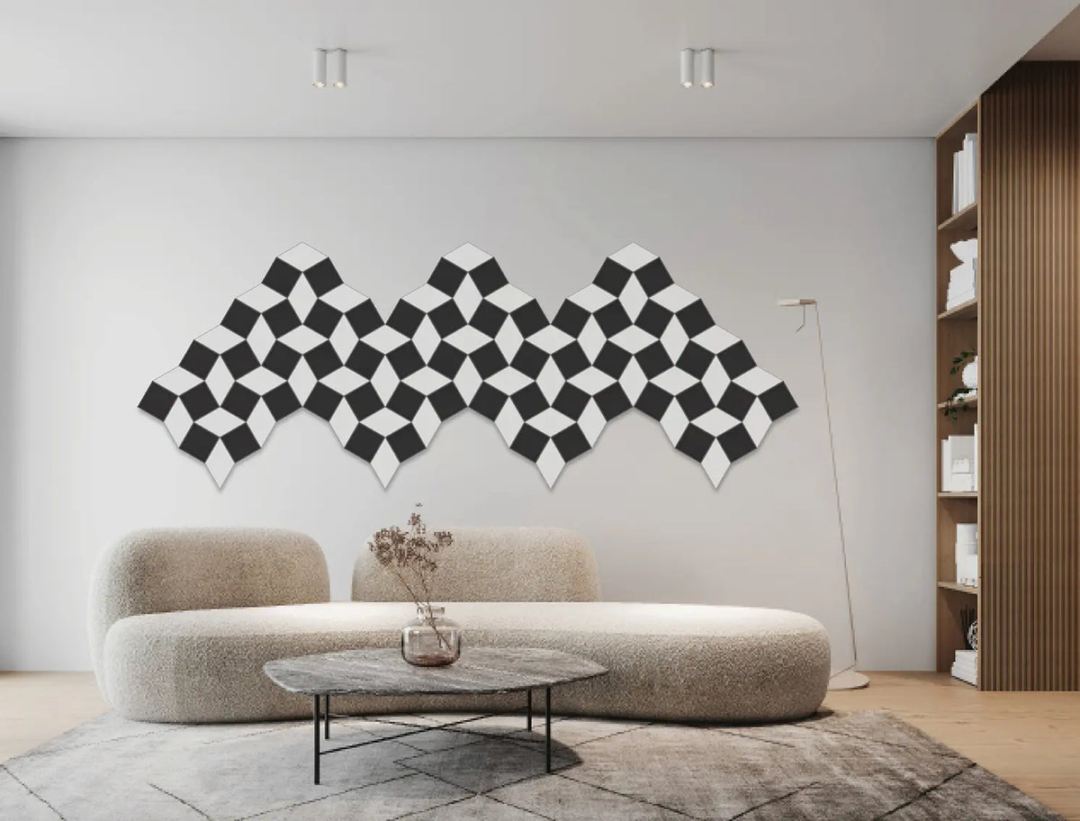 A modern living room featuring a large black and white 3D geometric cube wall art piece mounted on a light gray wall above a curved beige boucle sofa.
