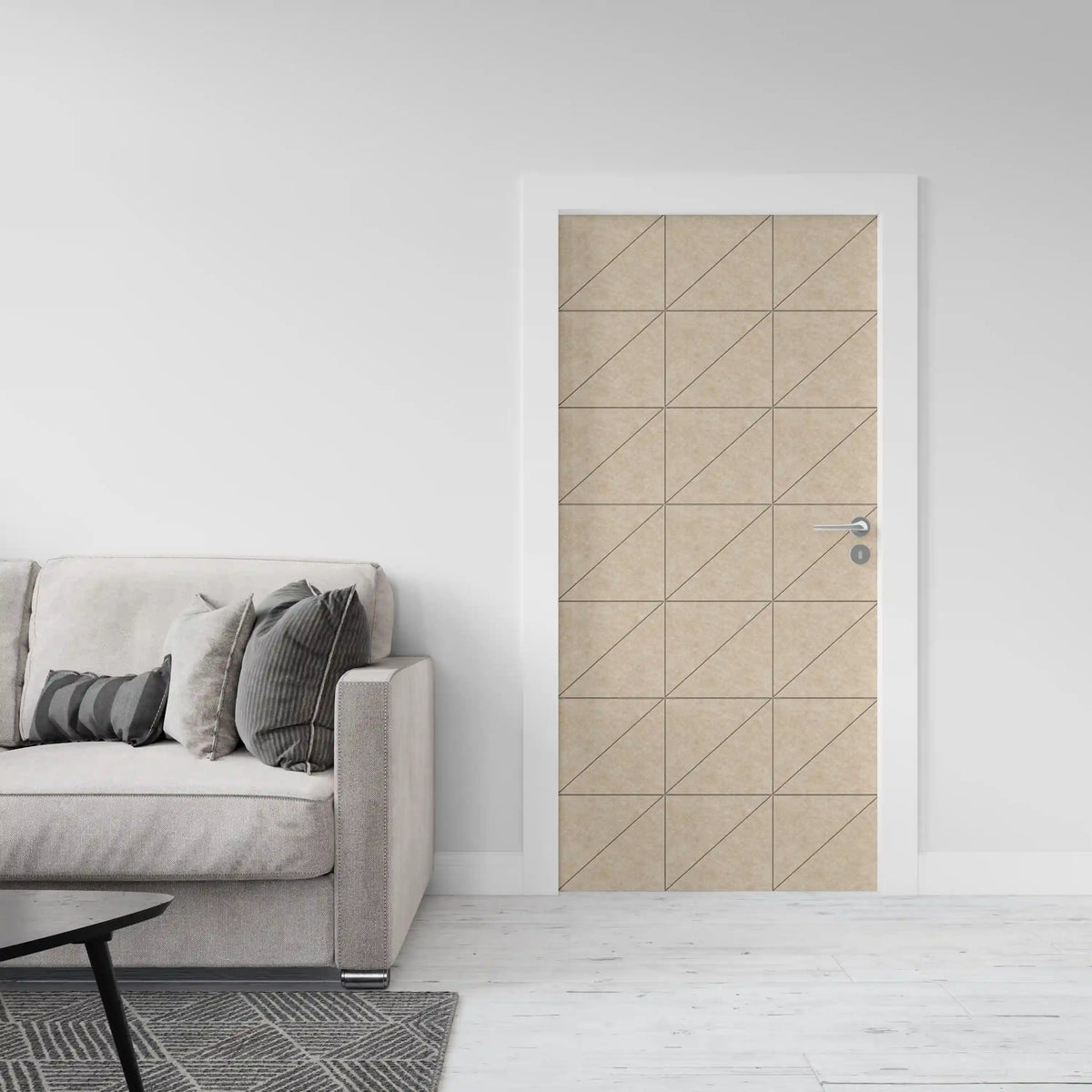 A modern interior room scene showing a beige door with a geometric grid pattern, set in a minimalist living space with a light gray sofa and white walls.