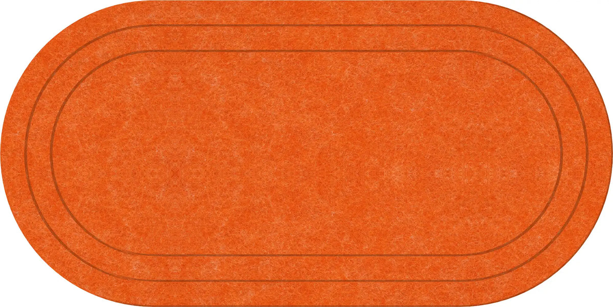 An oval-shaped orange rug with a textured surface and two concentric dark brown track lines, shown on a plain white background.