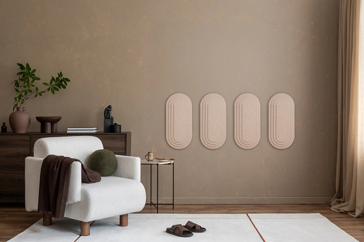 A room with 'Topo' 3D panels on the wall, a wooden table, a beige armchair, a standing lamp, and various decorative items.